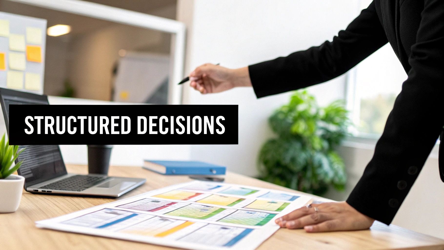 A person in a black blazer points at documents on a desk next to a laptop with "STRUCTURED DECISIONS" overlay.