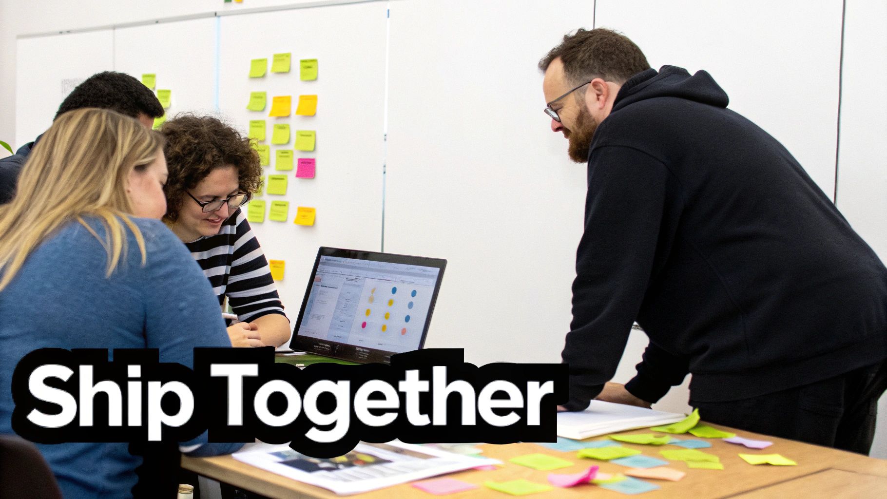 Two colleagues collaborating on a project with sticky notes on a glass wall