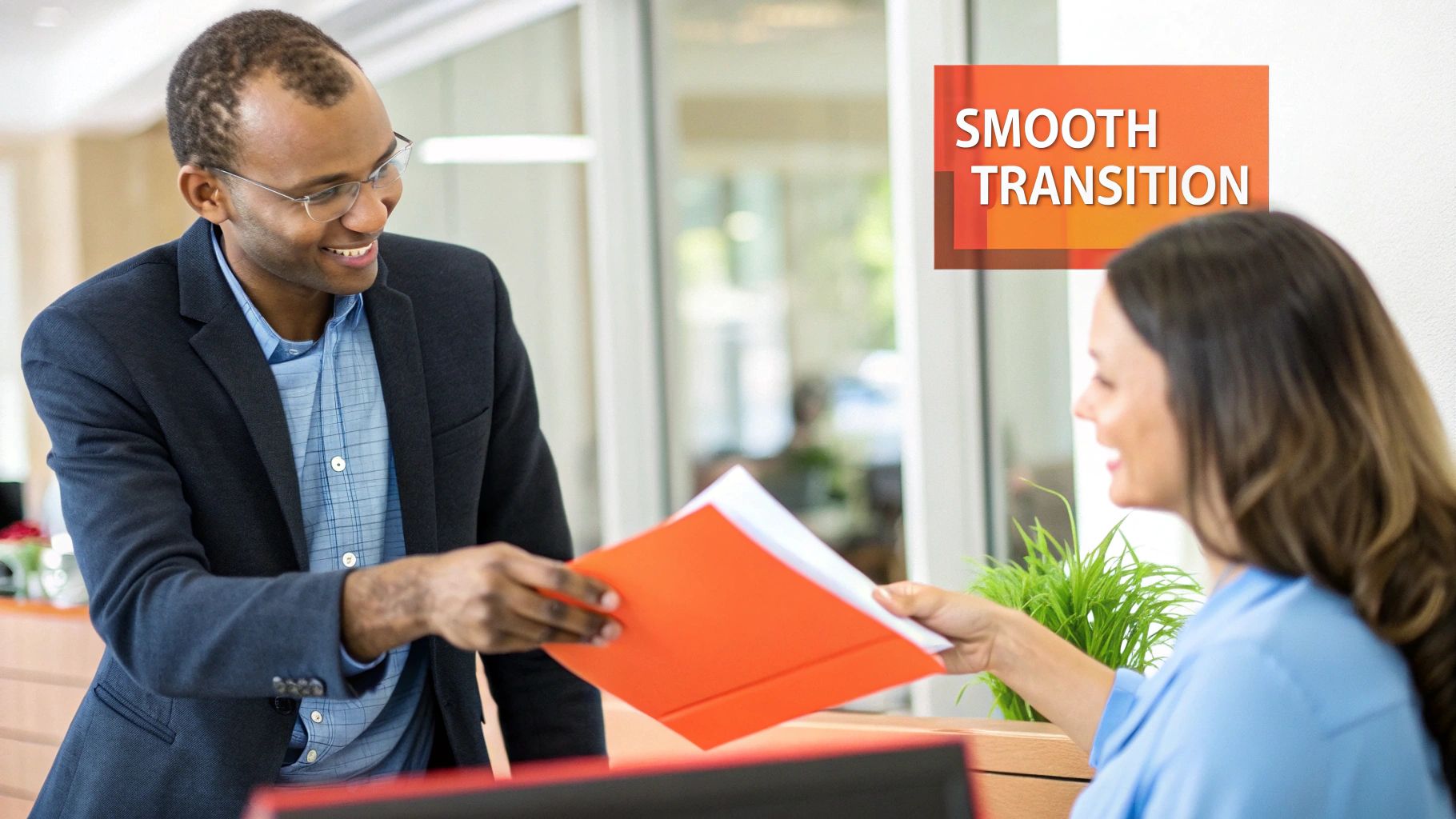 A manager shaking hands with a newly promoted employee in an office setting.