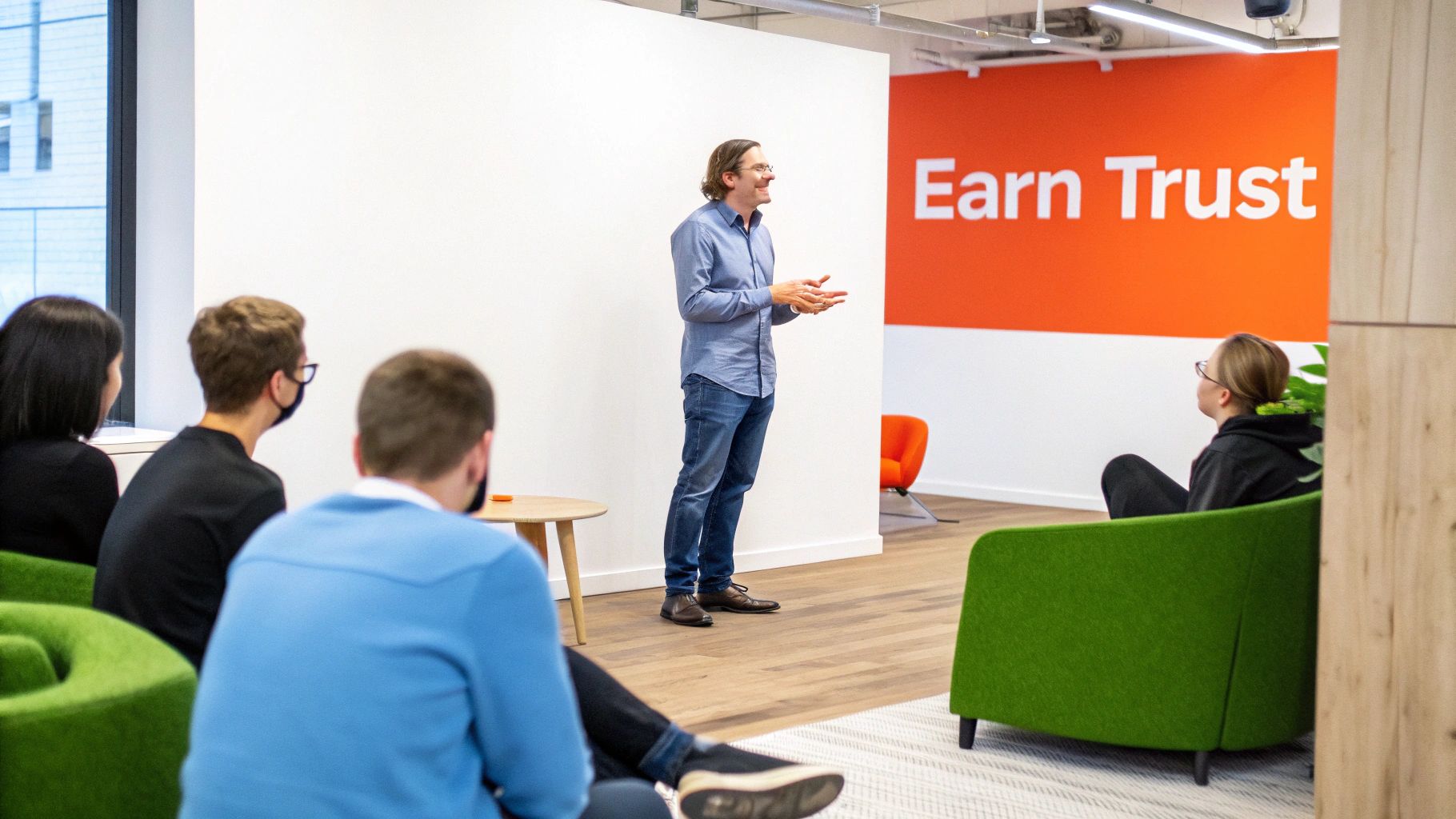 A speaker interacts with an audience during a presentation in a contemporary workspace.