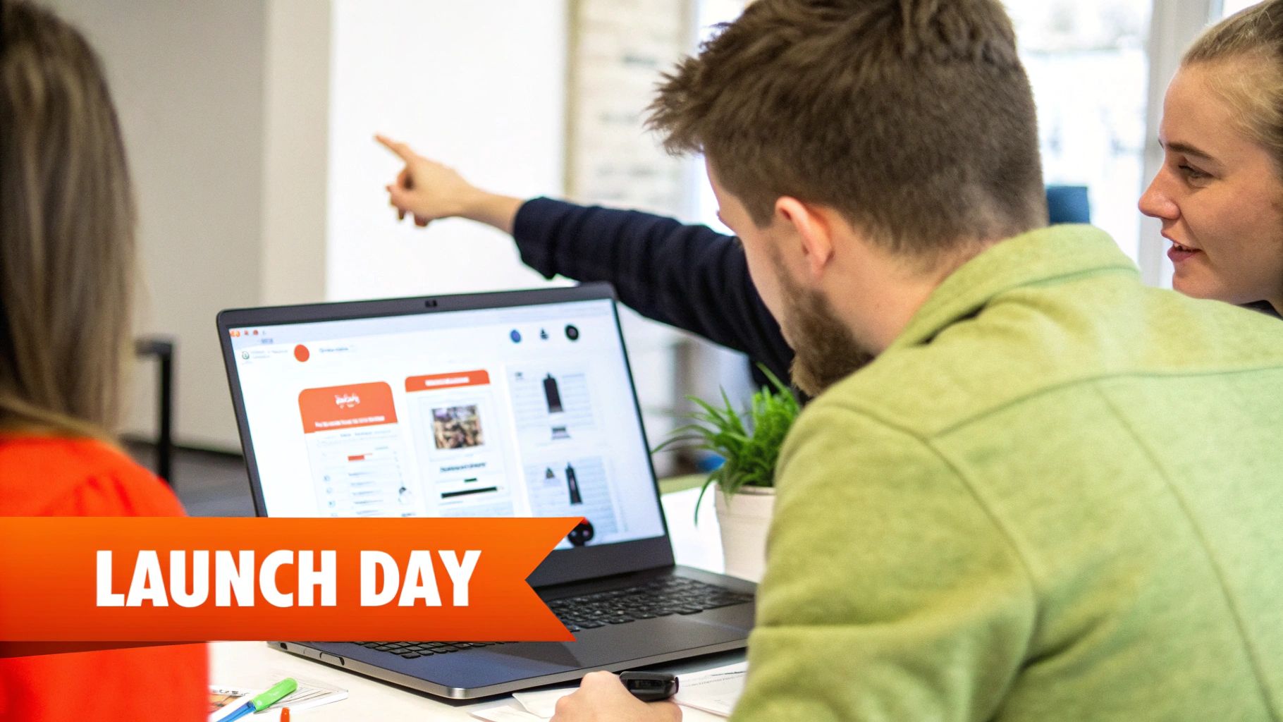 Team members collaborate around a laptop, viewing product listings on a website during a launch day.