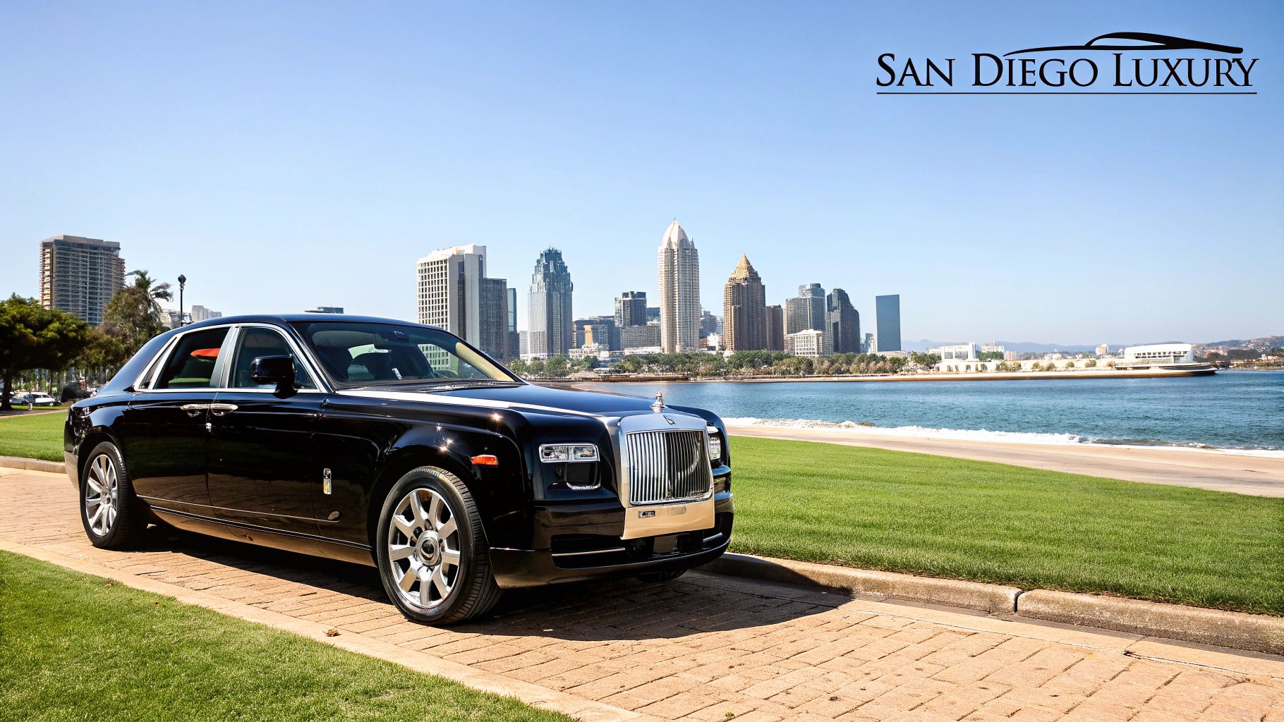 A white Rolls-Royce parked with a scenic San Diego ocean view in the background.