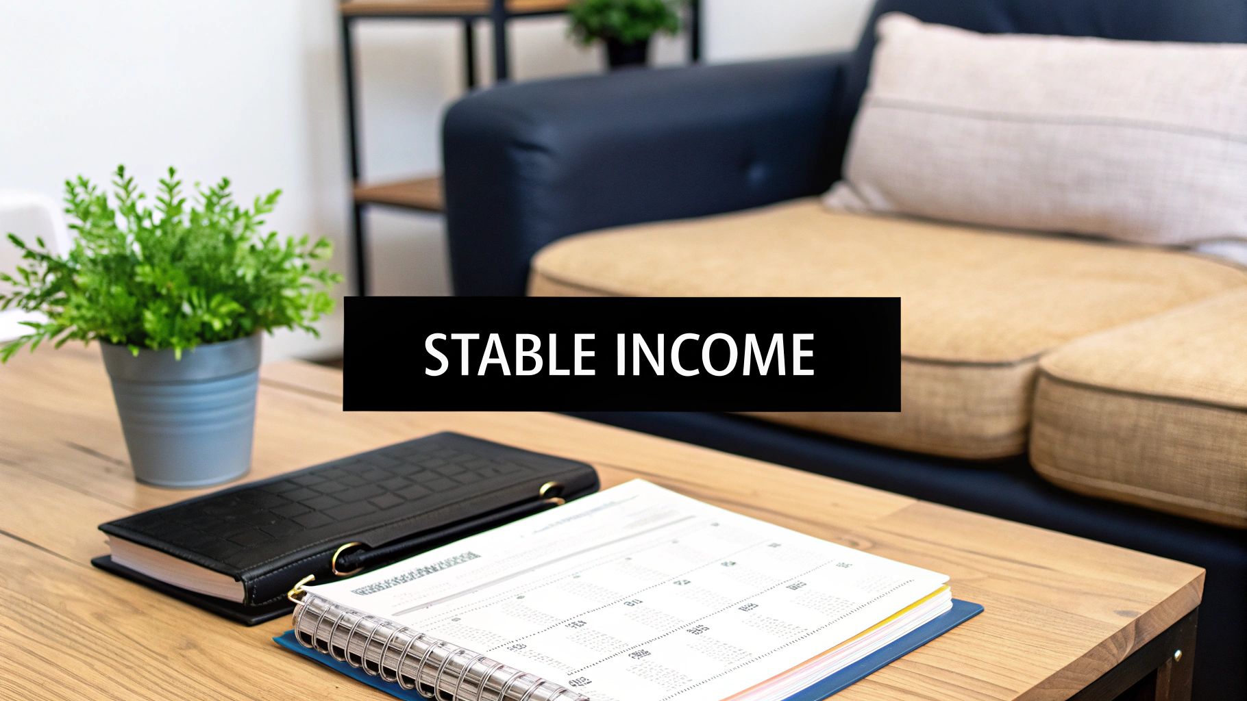 A home office desk with a plant, planner, and notebook, featuring a 'STABLE INCOME' banner.