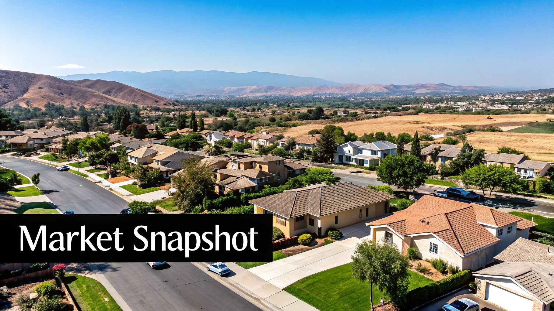 Aerial view of a suburban housing development with homes, streets, and distant hills under a clear sky, with a 'Market Snapshot' overlay.