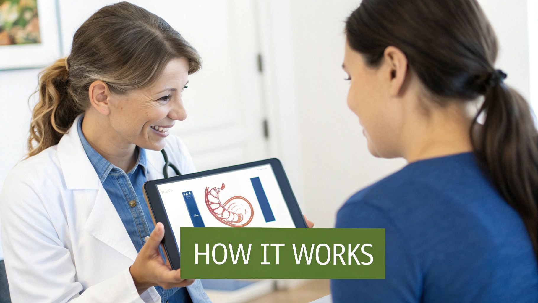 A smiling doctor shows a patient an anatomical diagram on a tablet, explaining how it works.