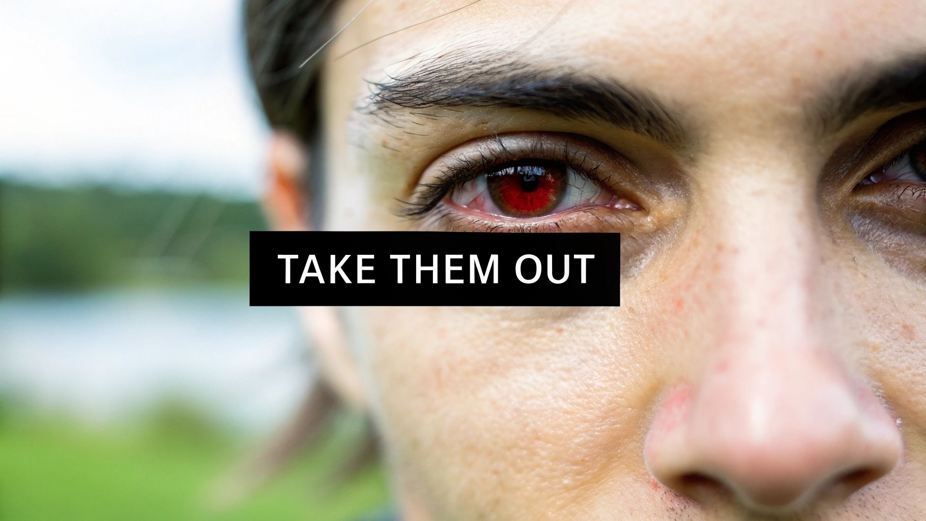 Close-up of a person's face with a red eye and a black bar stating 'TAKE THEM OUT'.