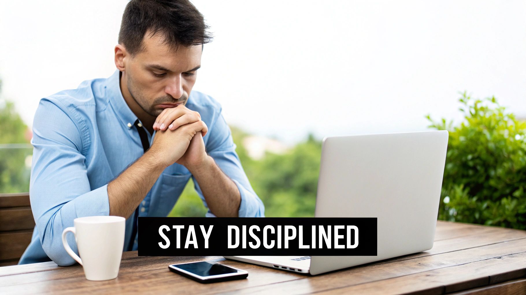 A focused man in a blue shirt looking at his laptop outdoors, with 'STAY DISCIPLINED' text.