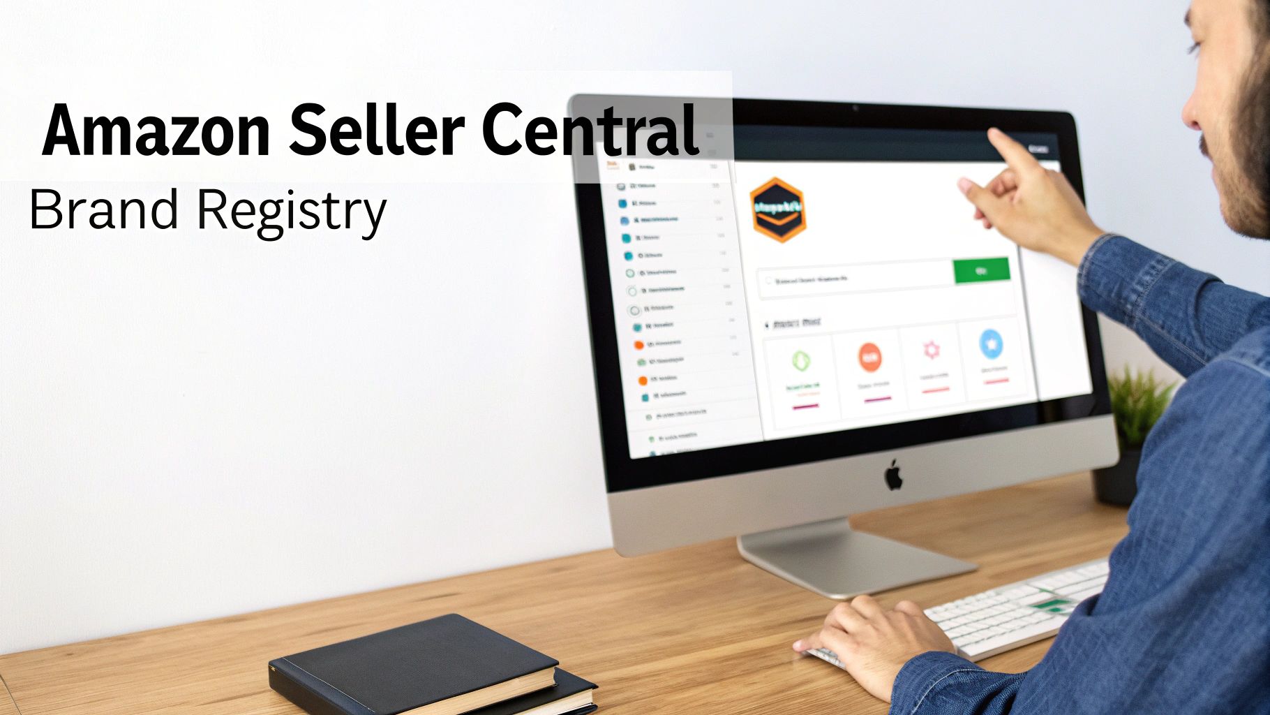 A person pointing at an Apple iMac screen displaying Amazon Seller Central Brand Registry interface on a wooden desk.