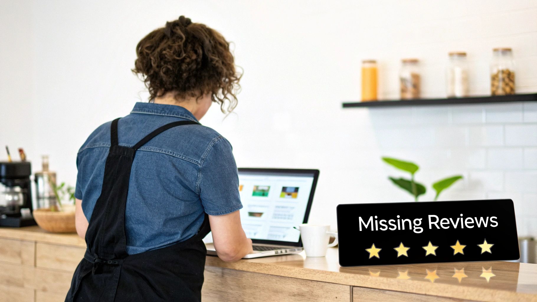 A small business owner checking their laptop with a sign reading 'Missing Reviews' and five stars.