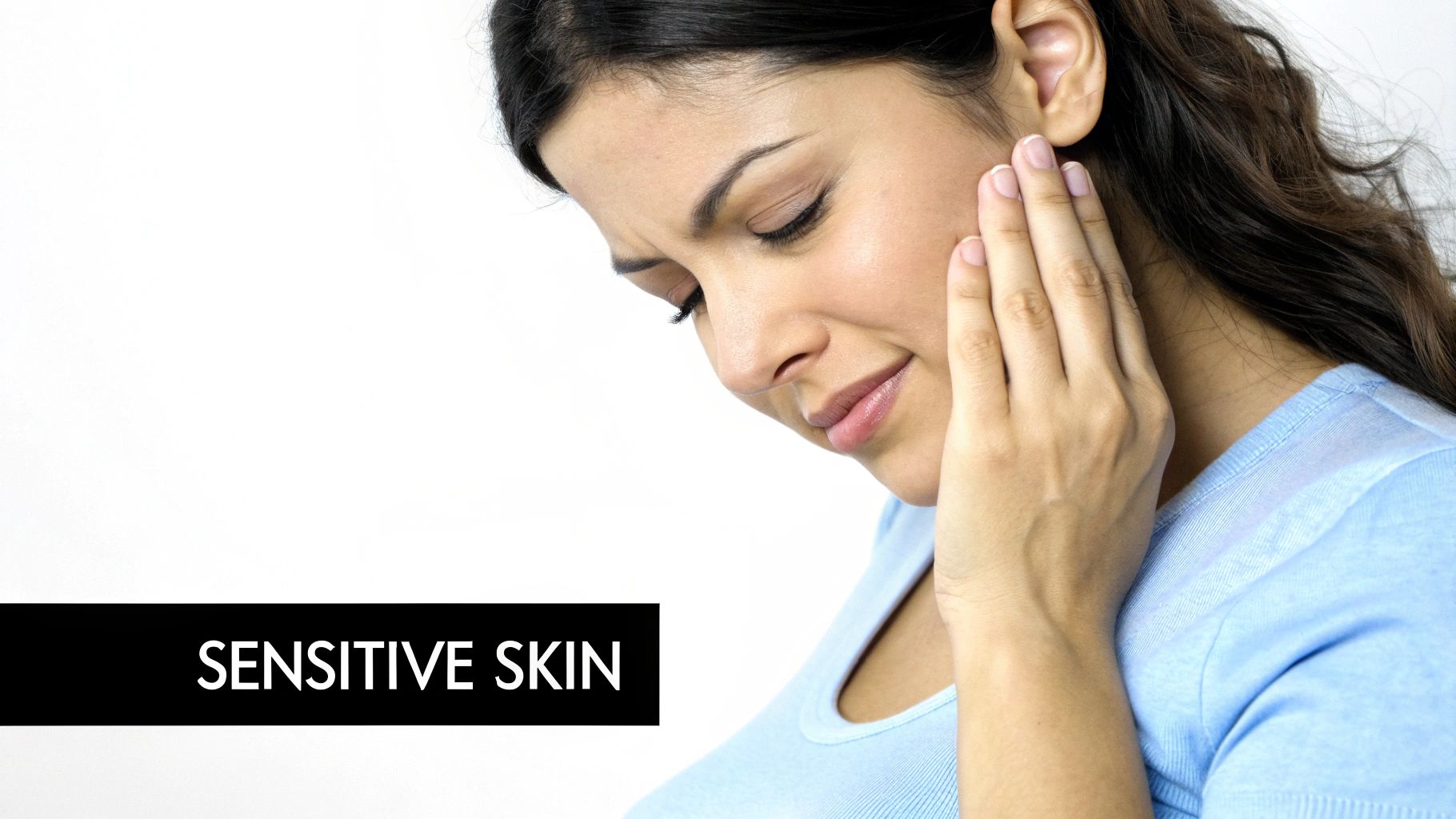 A woman touching her cheek, looking distressed, indicating sensitive skin or discomfort.