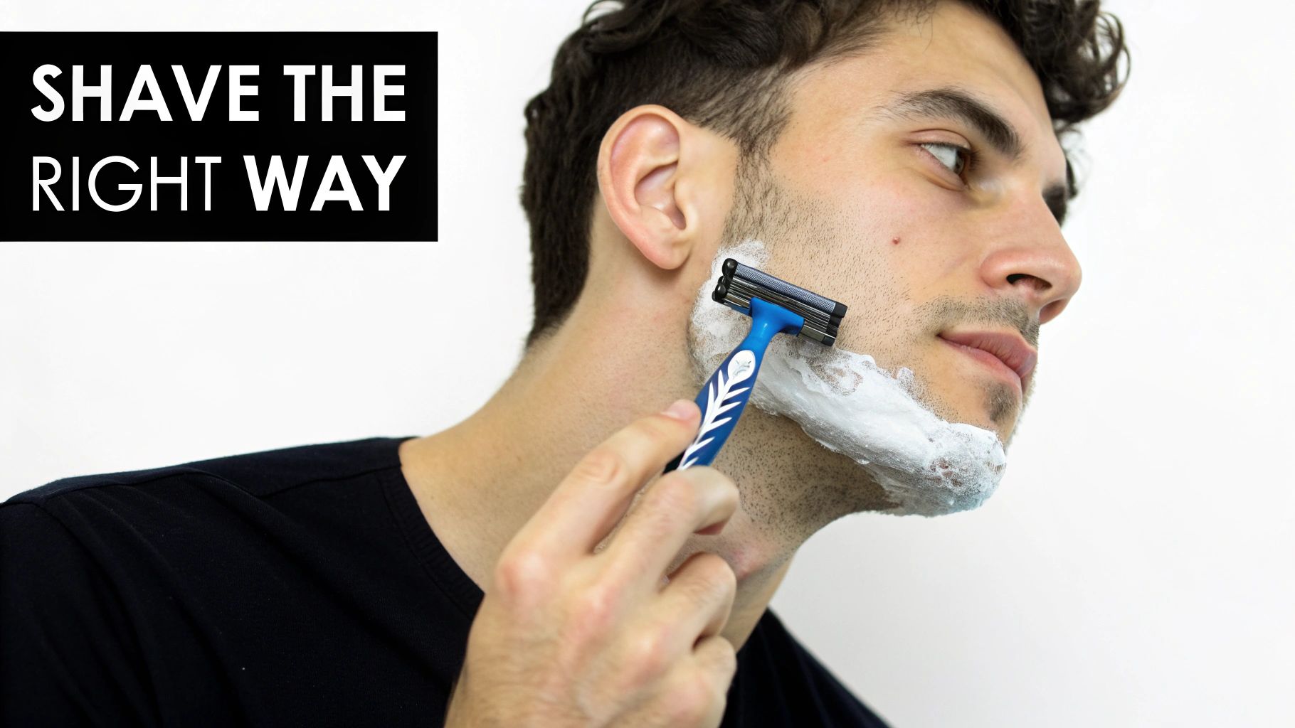 Close-up of a man shaving his cheek and jawline with a blue multi-blade razor.