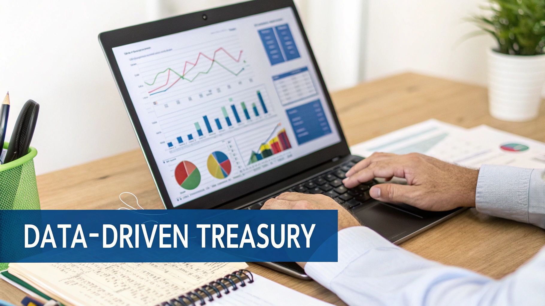 Hands typing on a laptop displaying data-driven financial charts and graphs for treasury management.