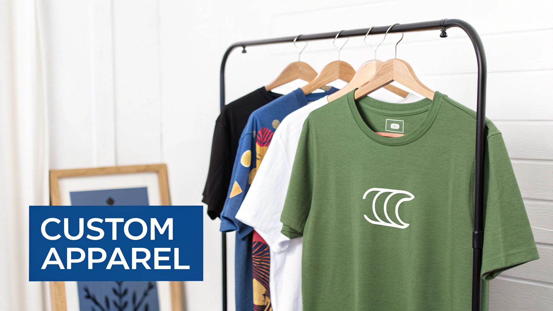 A clothing rack displays multiple custom apparel t-shirts in various colors, emphasizing bespoke design services.