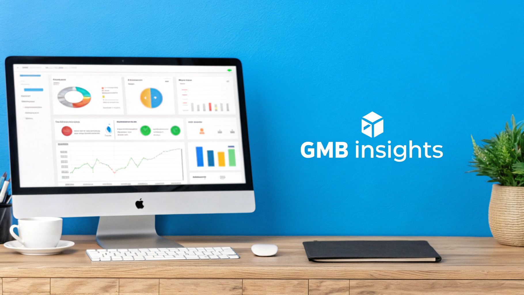 A desk setup featuring an iMac displaying a GMB insights dashboard with various charts and graphs.