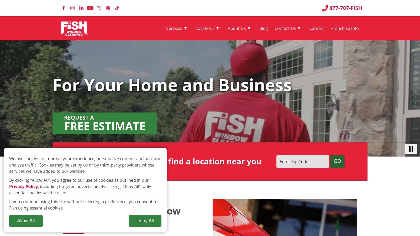 A professional window cleaner uses specialized equipment on a commercial building, reflecting the services offered by Fish Window Cleaning.