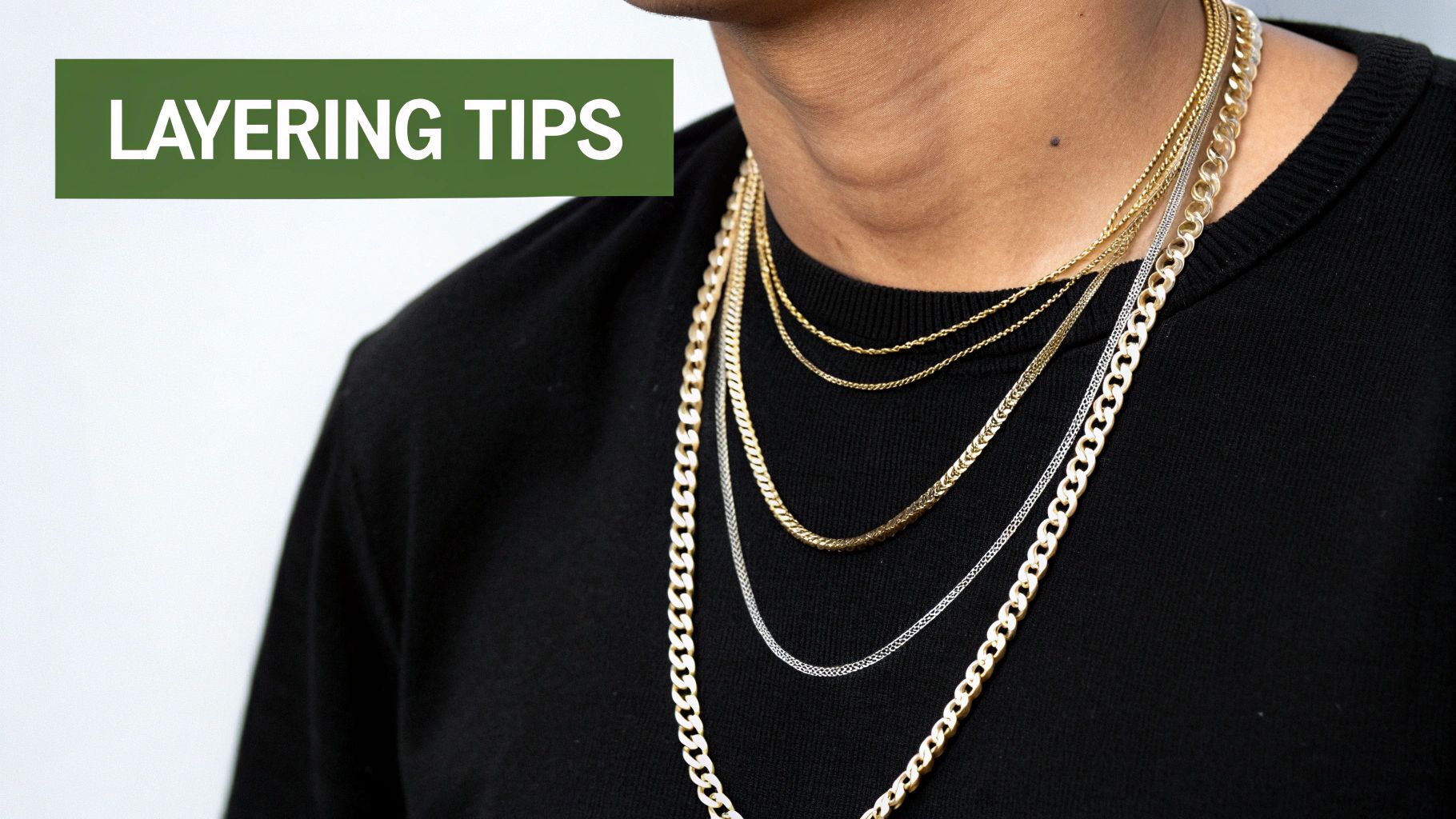 A woman with a petite frame wearing a large, beaded necklace that contrasts beautifully with her simple cotton t-shirt.
