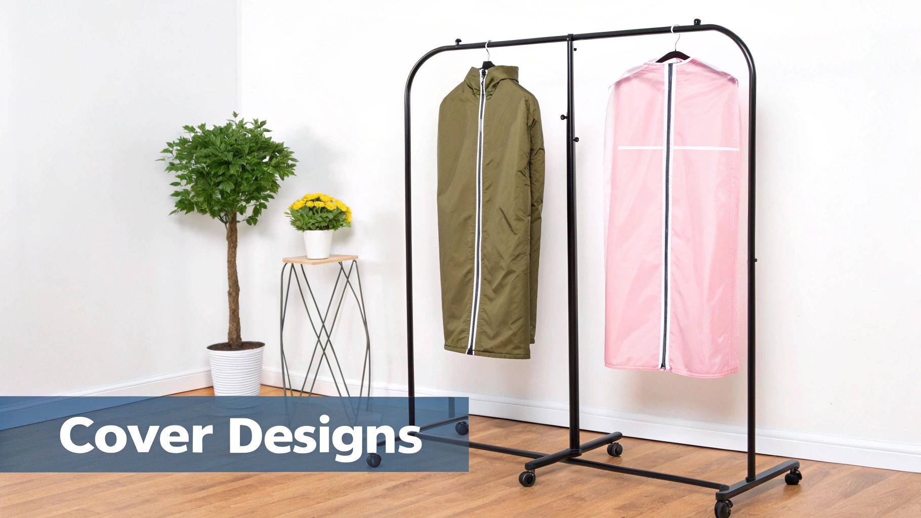 Mobile black clothing rack displaying garment covers in pink and olive green with decorative plants nearby