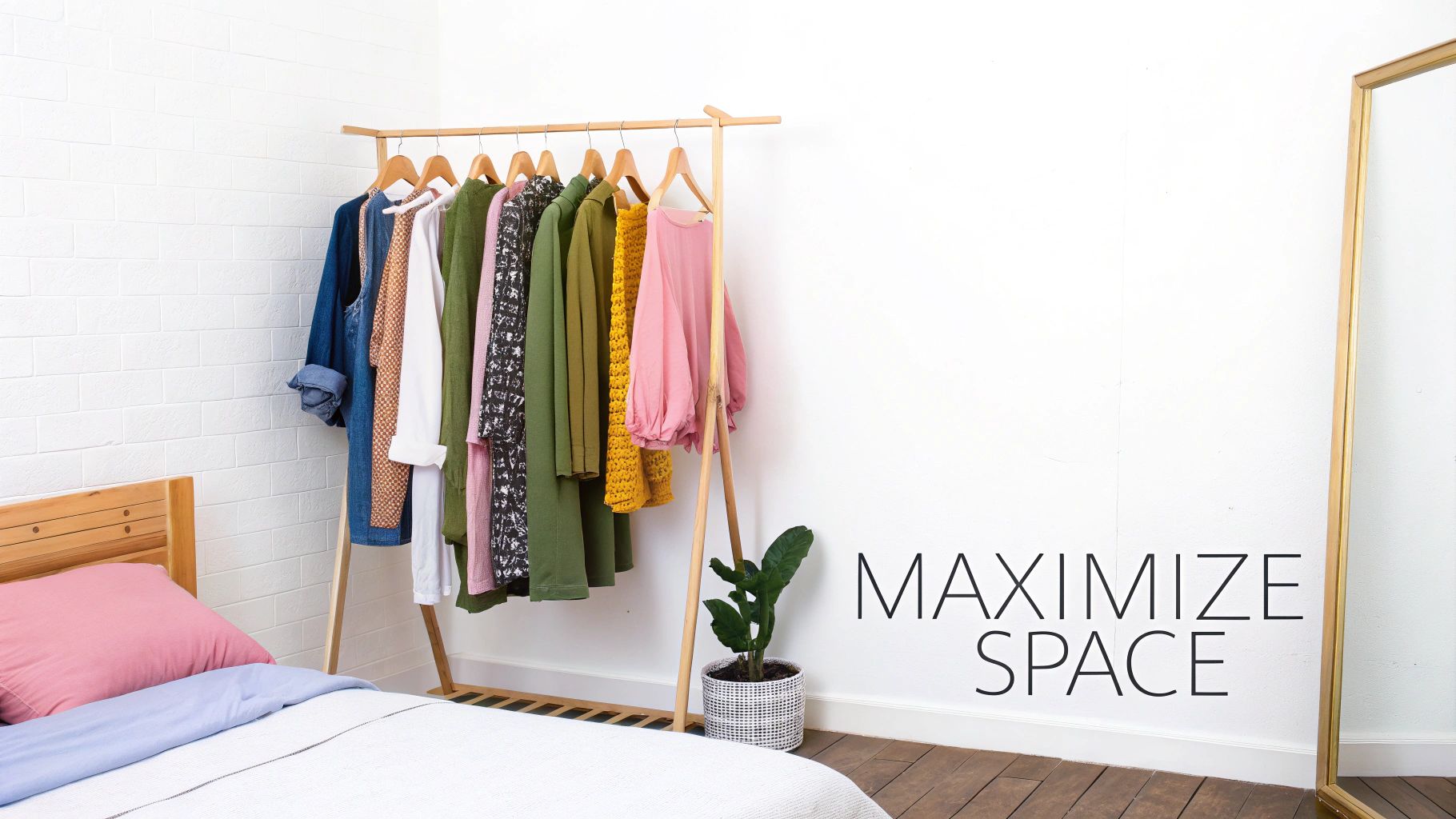 A wooden clothes rail with diverse clothing, a bed, mirror, and 'MAXIMIZE SPACE' text in a modern room.