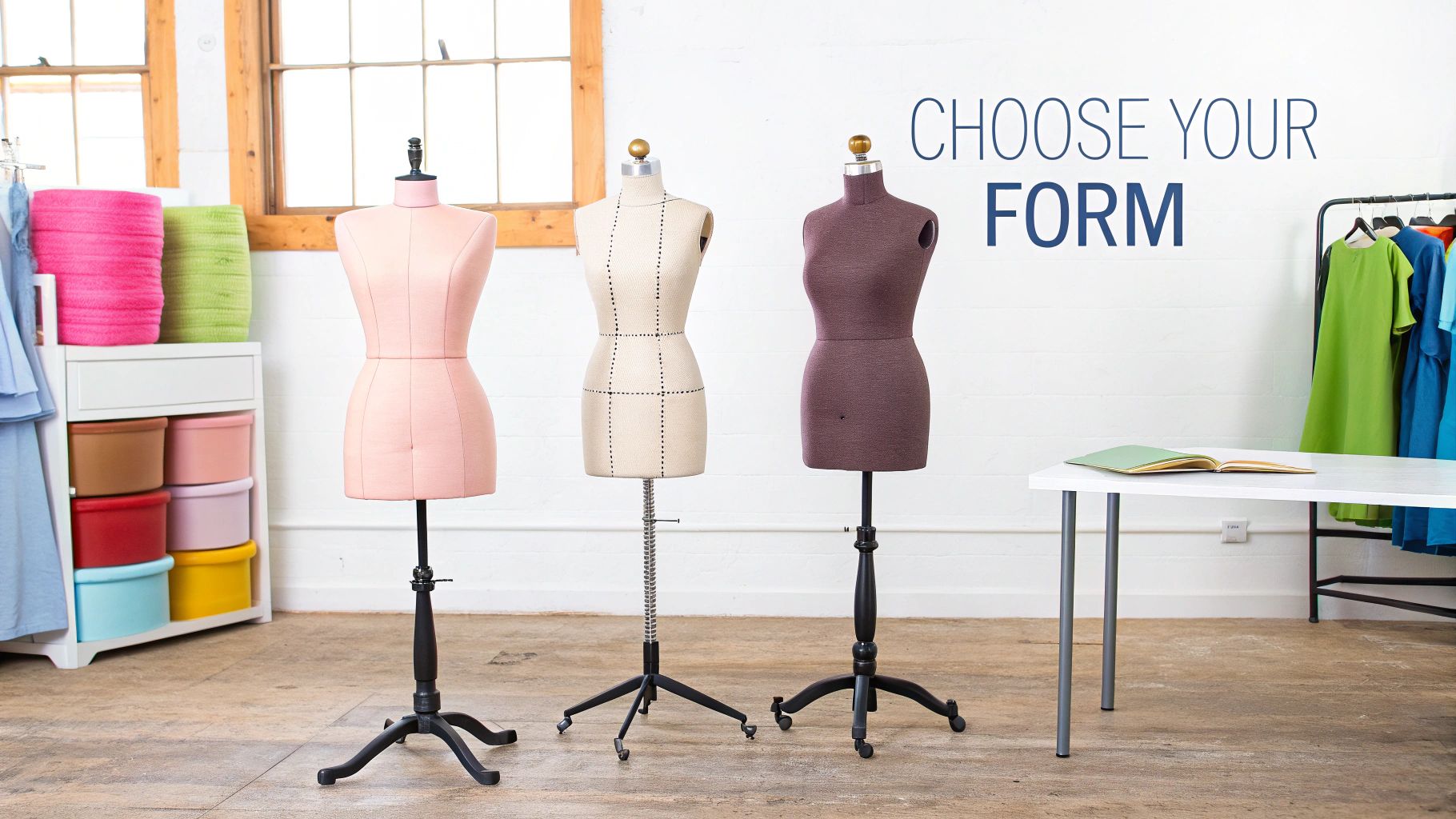 Three dress forms of different colors and styles stand in a bright design studio.
