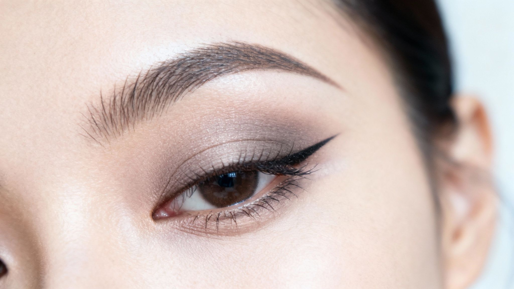 Oko kobiety z artystycznym makijażem podkreślającym jego kształt