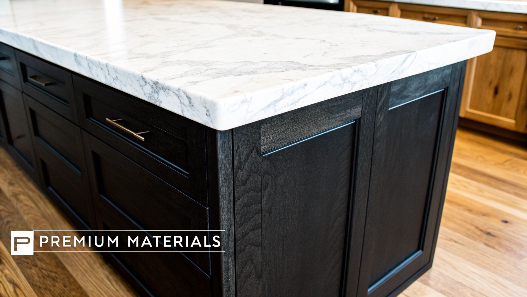 Why an Angled Kitchen Island Is a Mark of True Luxury Design Modern kitchen island featuring a white marble countertop, dark wood cabinets, and gold hardware.