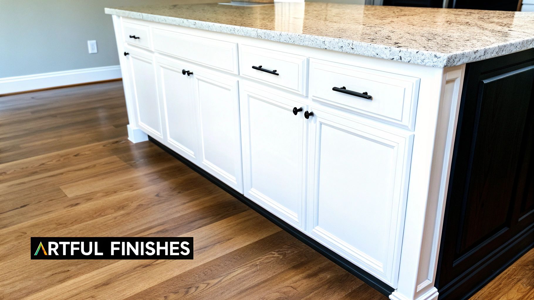 Custom Home Construction Process Nashville: A Guide to Building Your Luxury Home A modern kitchen island with white cabinets, black hardware, granite countertop, and wood floor.