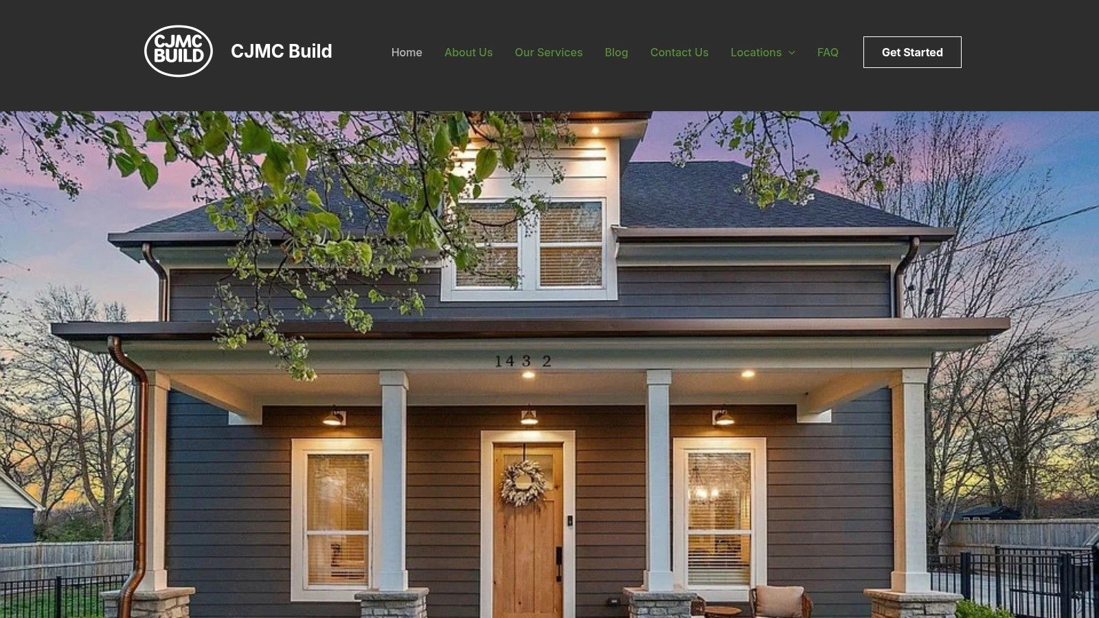 A modern farmhouse exterior by CJMC Build in the Nashville area, featuring white siding, a dark roof, and a prominent front porch.