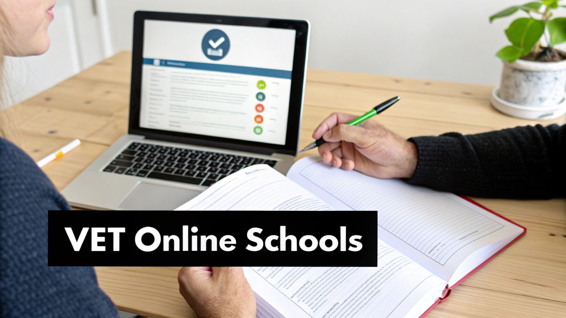 Two students engaged in online learning, using a laptop and writing in a notebook on a wooden desk.