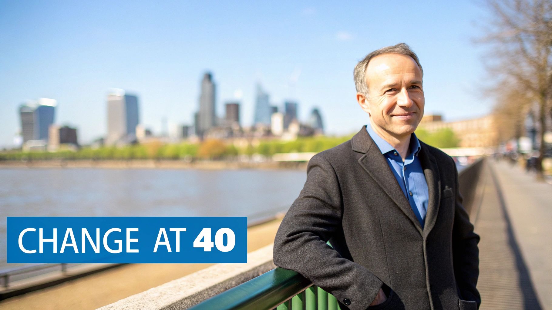 A smiling man in a coat by a river with a city skyline, next to a 'CHANGE AT 40' banner.
