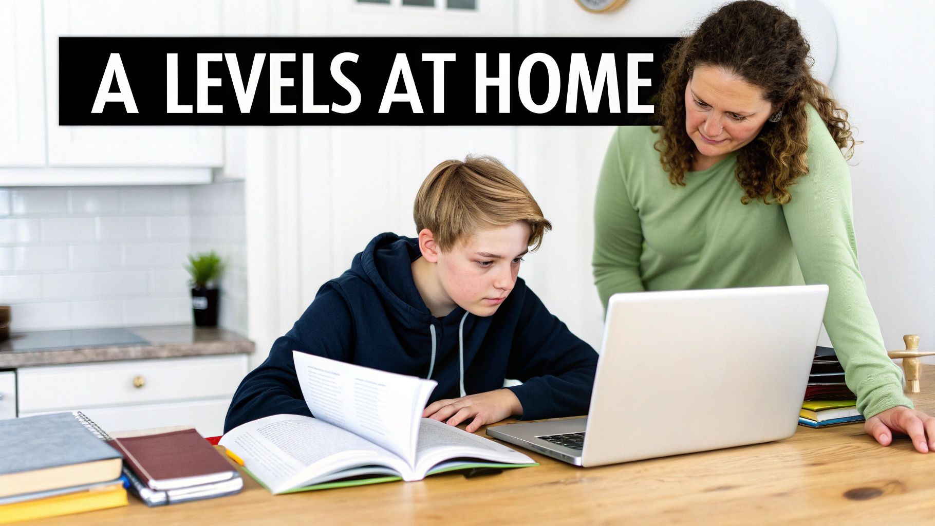 A parent and teenager studying together at a desk at home, looking positive and engaged.