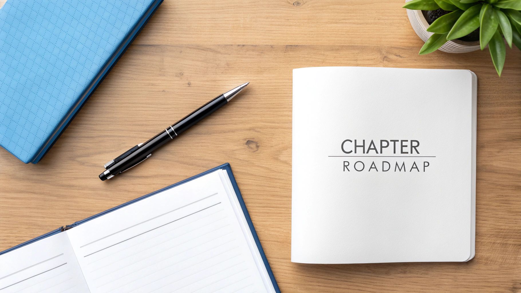 Overhead view of a wooden desk with a 'Chapter Roadmap' booklet, notebooks, and a pen.