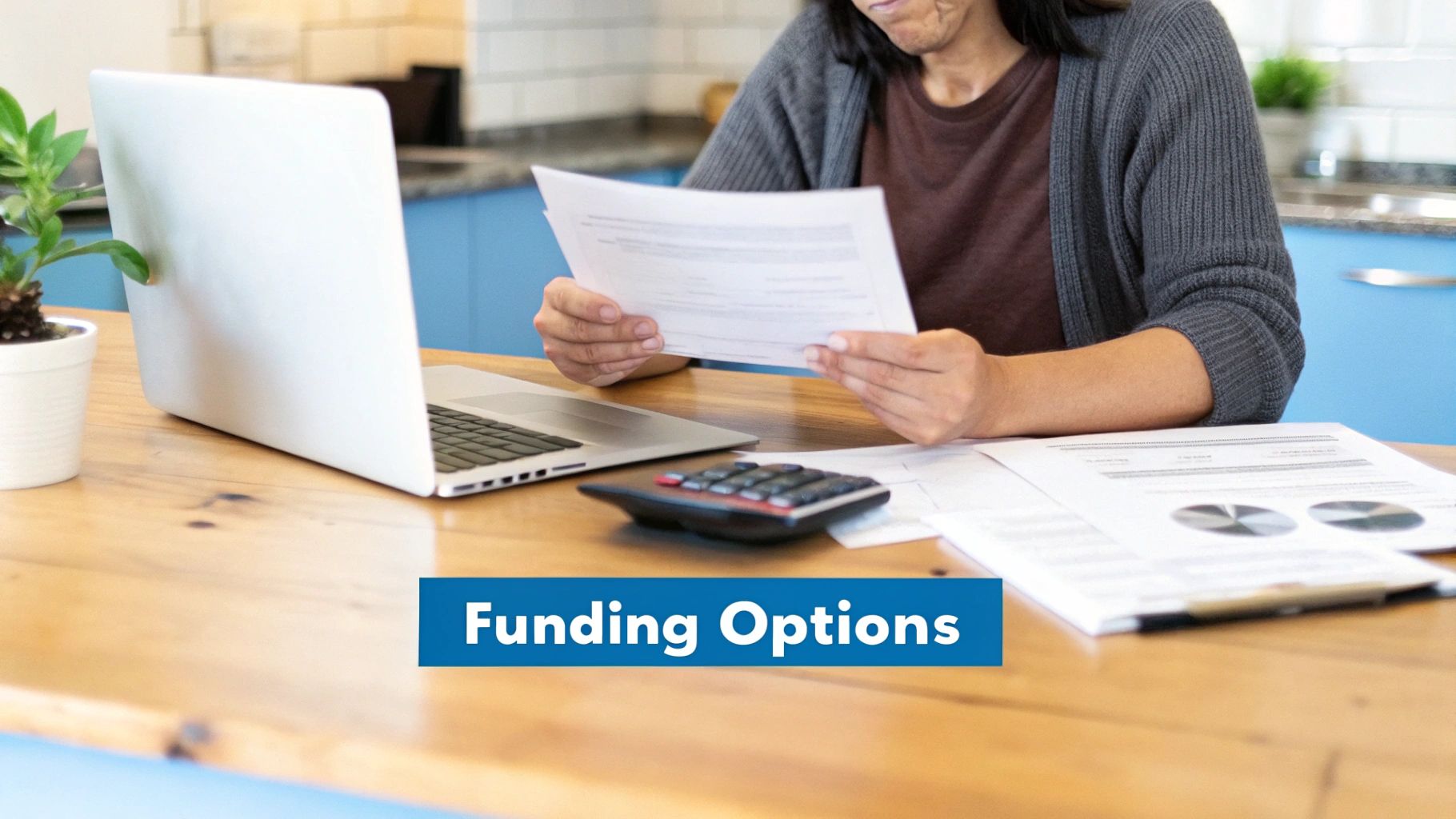 A student looking relieved while reviewing financial documents on a laptop, with a piggy bank and calculator on the desk.