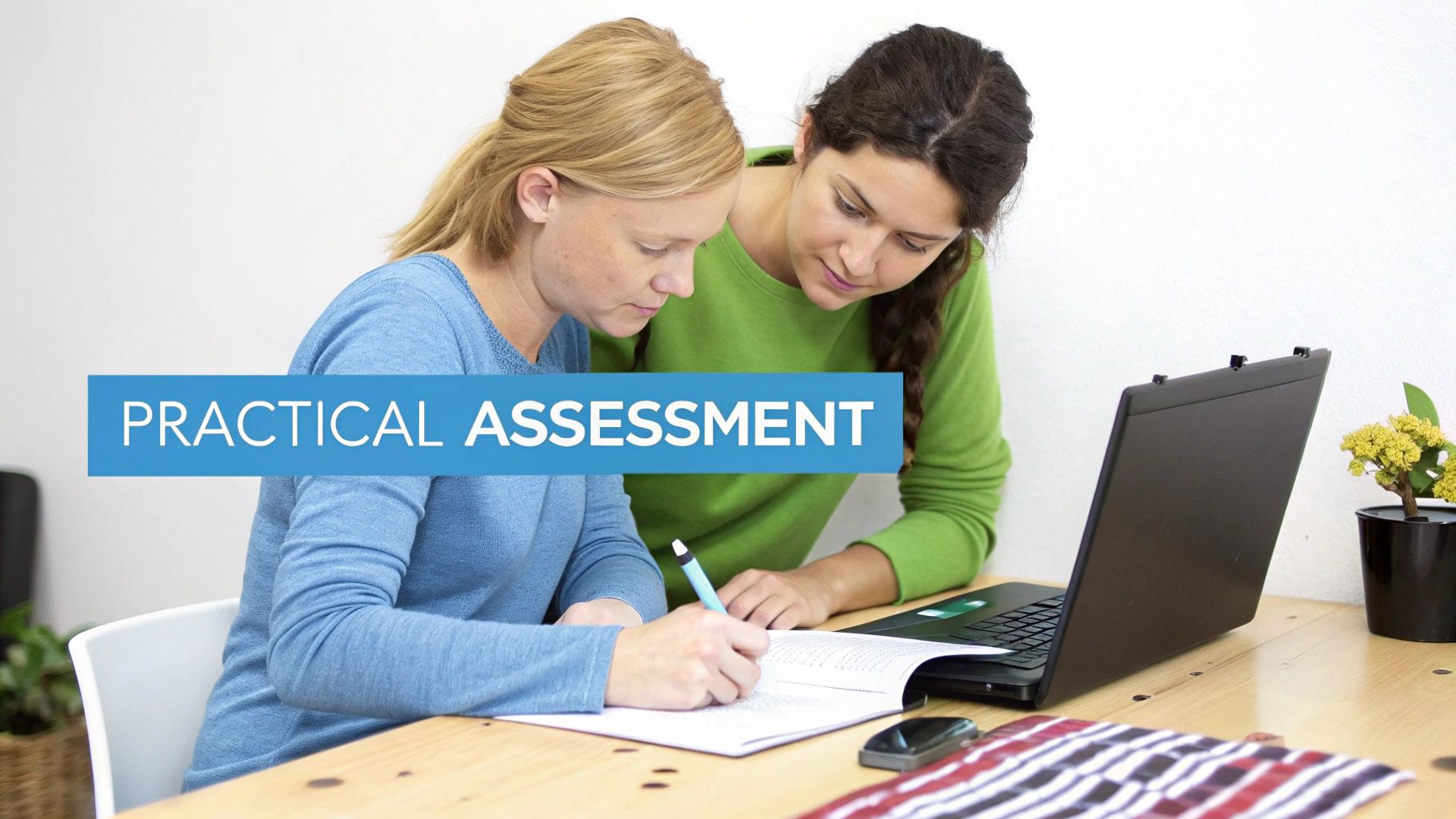 A person at a desk using a laptop and writing in a notebook, focused on learning.