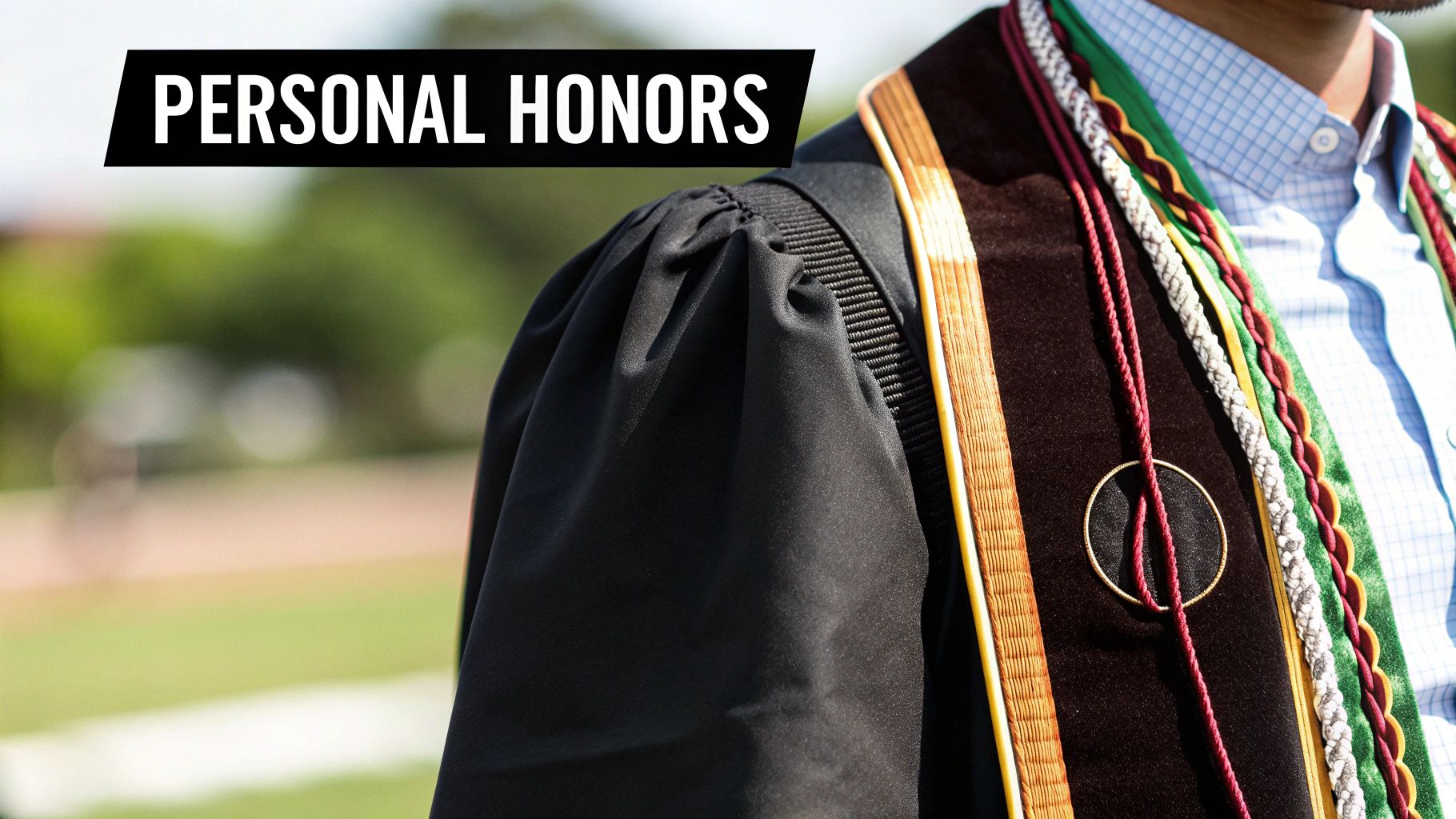 Close-up of a graduate in black academic regalia with colorful honor cords and stoles.