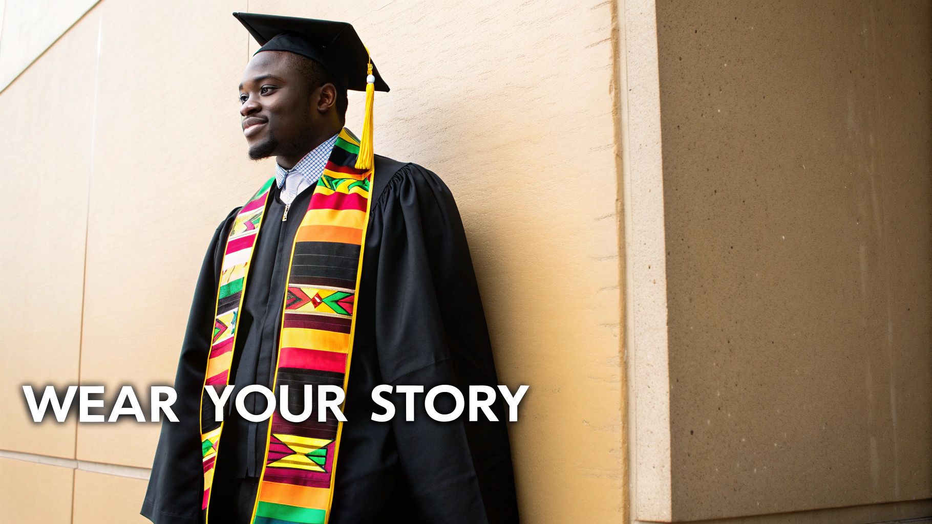 A smiling graduate in a cap, gown, and a vibrant Kente stole, looking confidently.