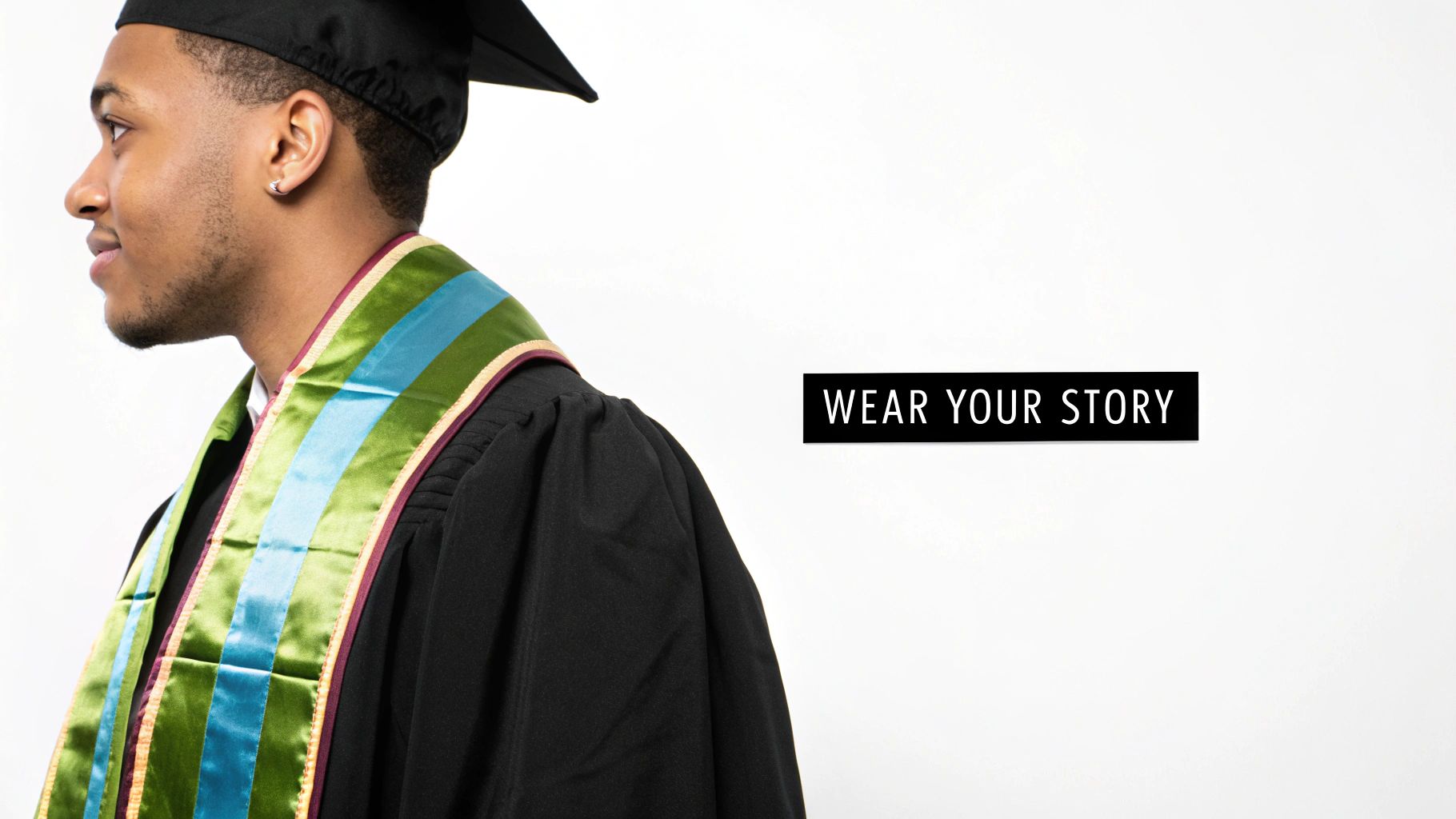 Close-up of a smiling graduate in a black gown and cap, adorned with a green and blue striped stole.