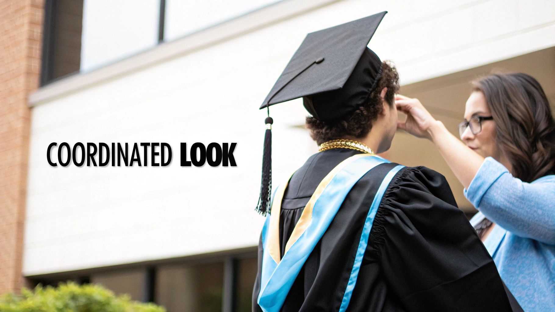 A person in a black graduation cap and gown, with a woman adjusting their attire.