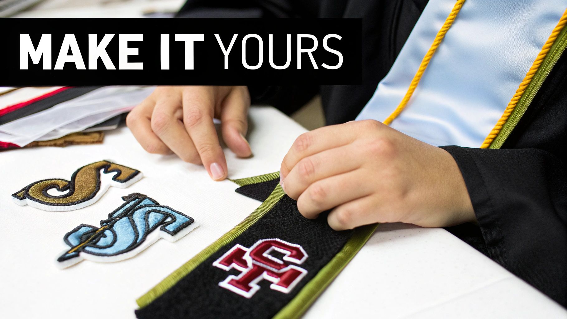Hands customize a black graduation stole with embroidered patches, featuring a light blue stole and 'MAKE IT YOURS' text.