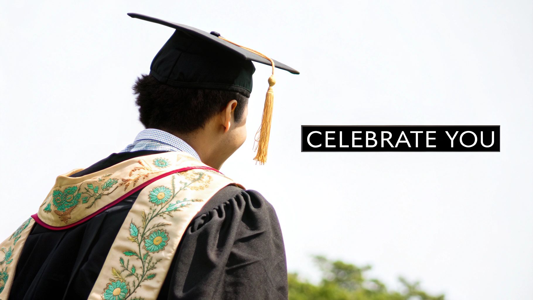 A group of graduates proudly wearing their customized graduation stoles over their gowns, smiling together.