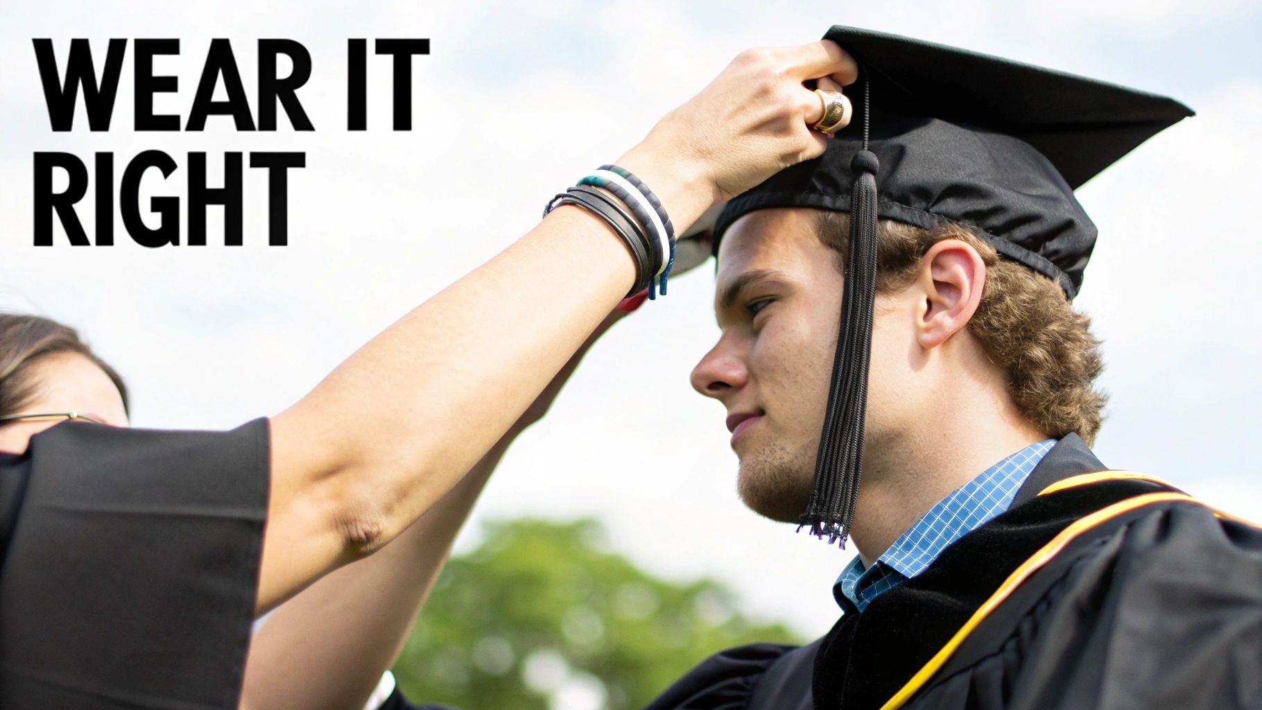 A graduate smiling while adjusting their master's degree graduation gown