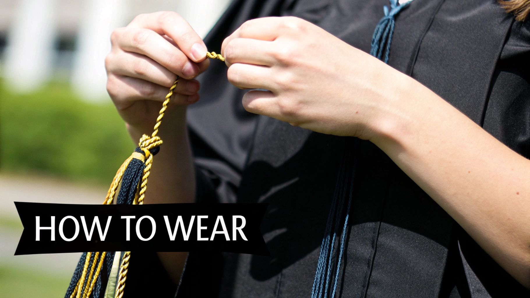 Graduate in black gown adjusting gold and navy honor cords during commencement ceremony