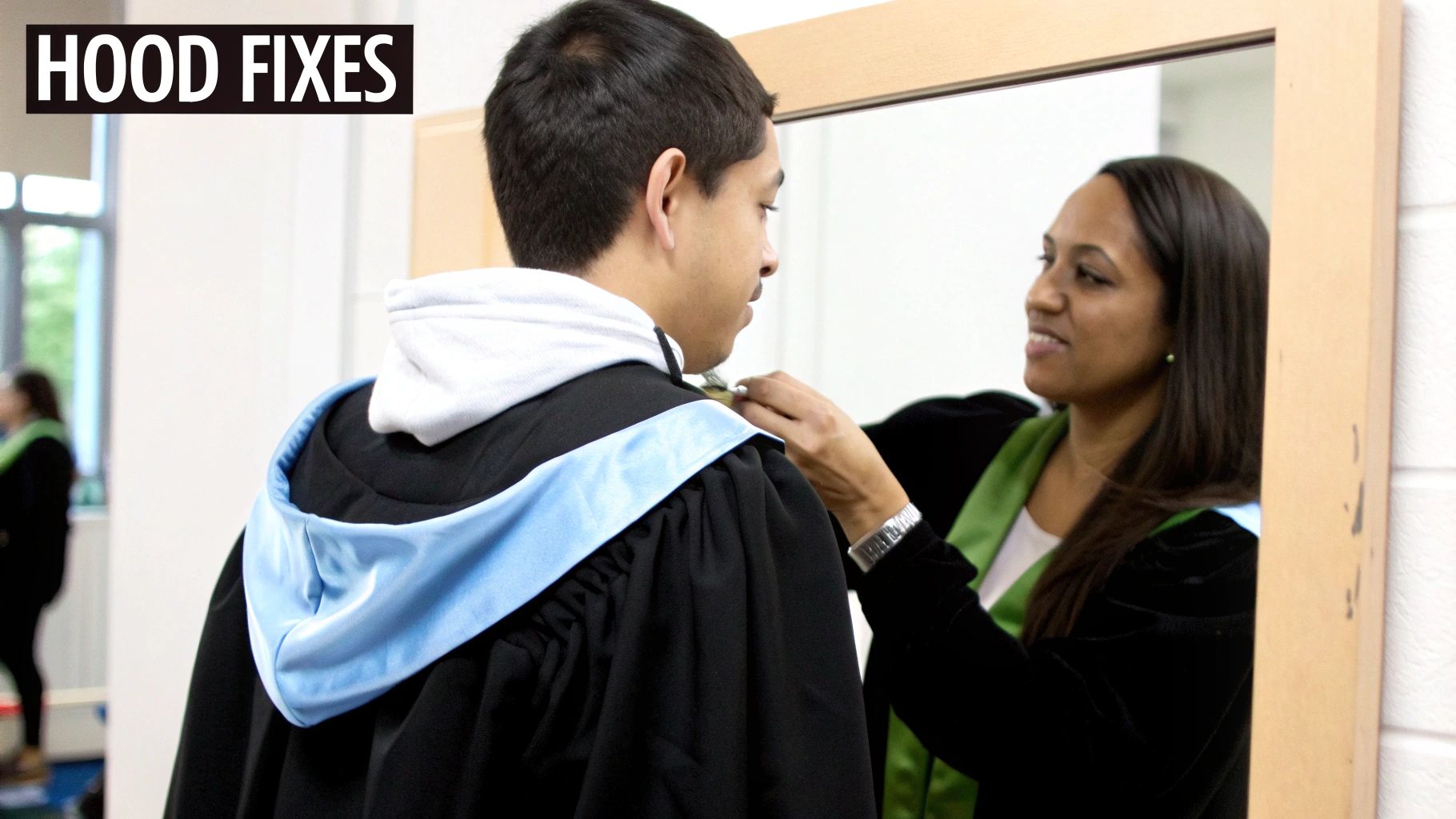 A woman adjusts a male graduate's light blue academic hood, preparing for a ceremony.