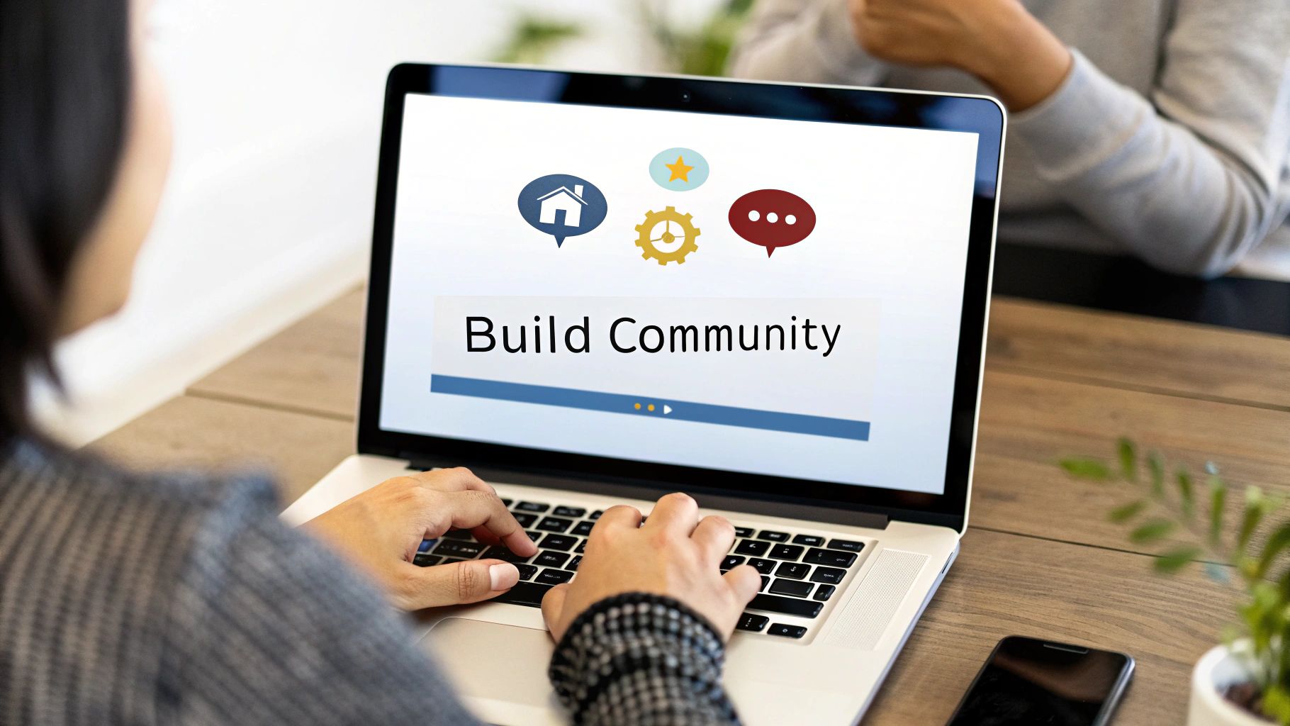 A person types on a laptop displaying 'Build Community' with house, gear, and chat icons.