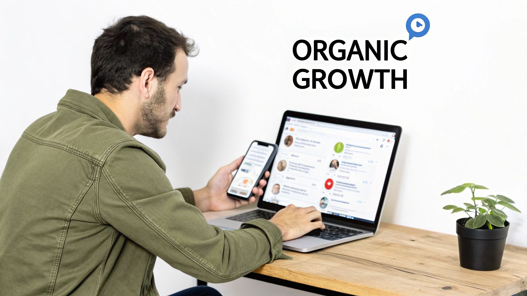Man working on laptop and phone for organic growth, focusing on digital marketing strategies.