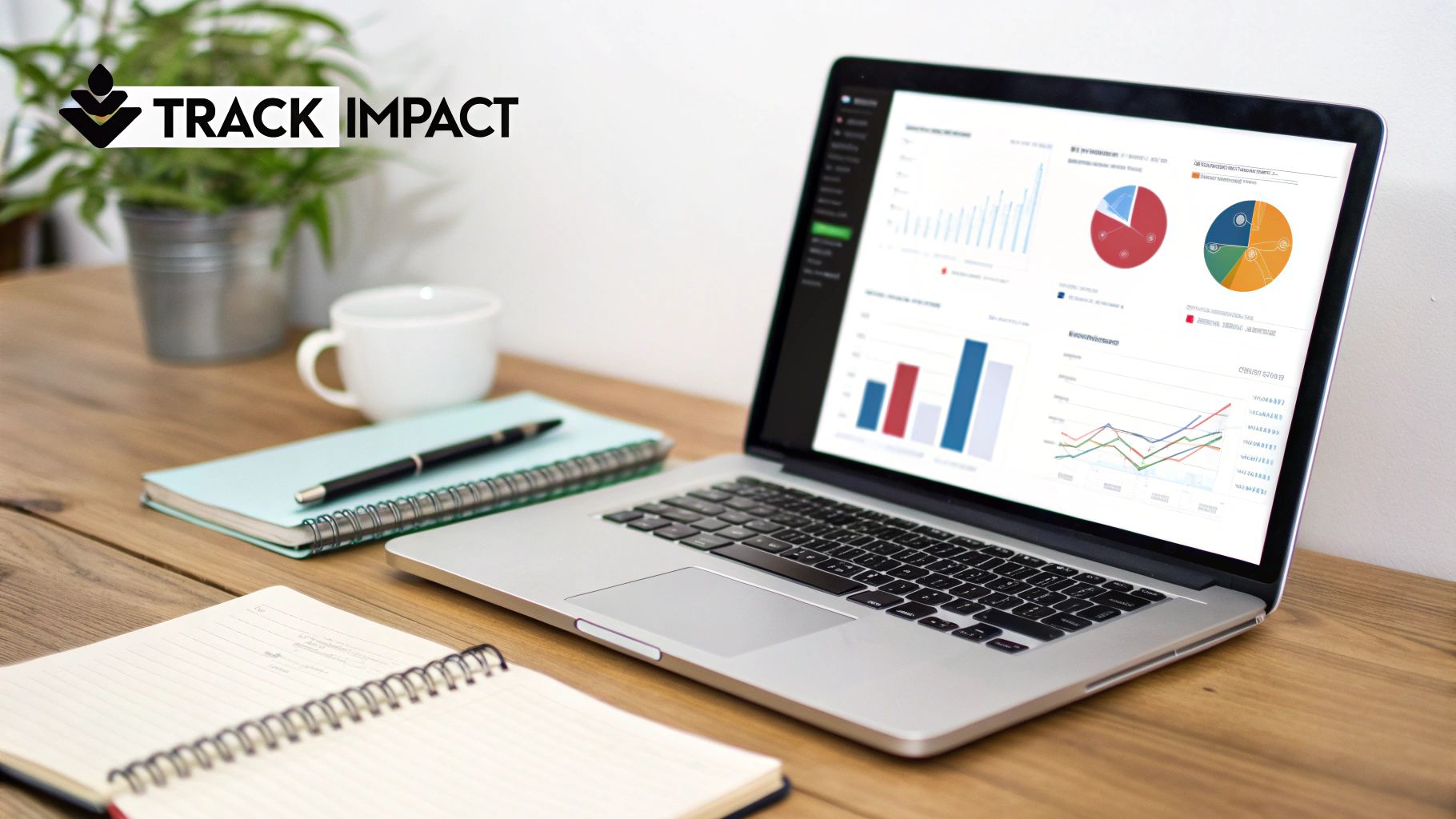 A laptop on a wooden desk displays various data graphs, charts, and analytics, next to notebooks and a coffee cup.