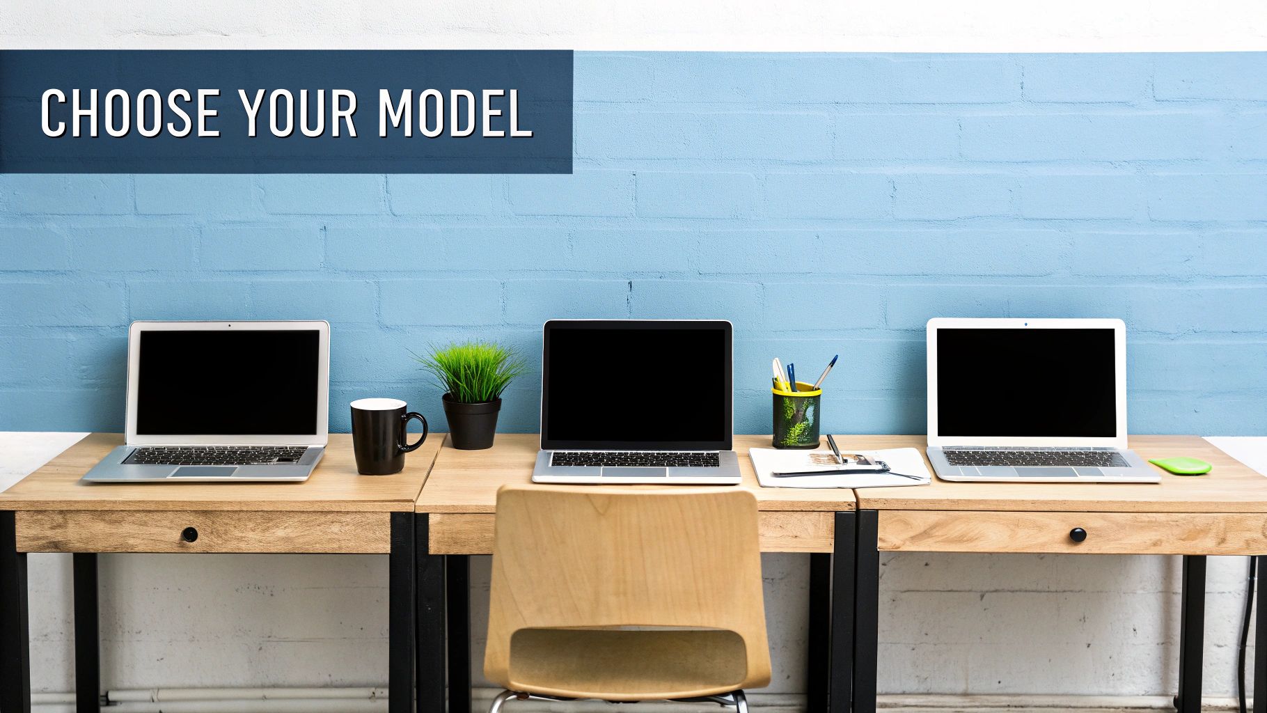 A bright workspace featuring three identical desks, each with a laptop, mug, and a plant.