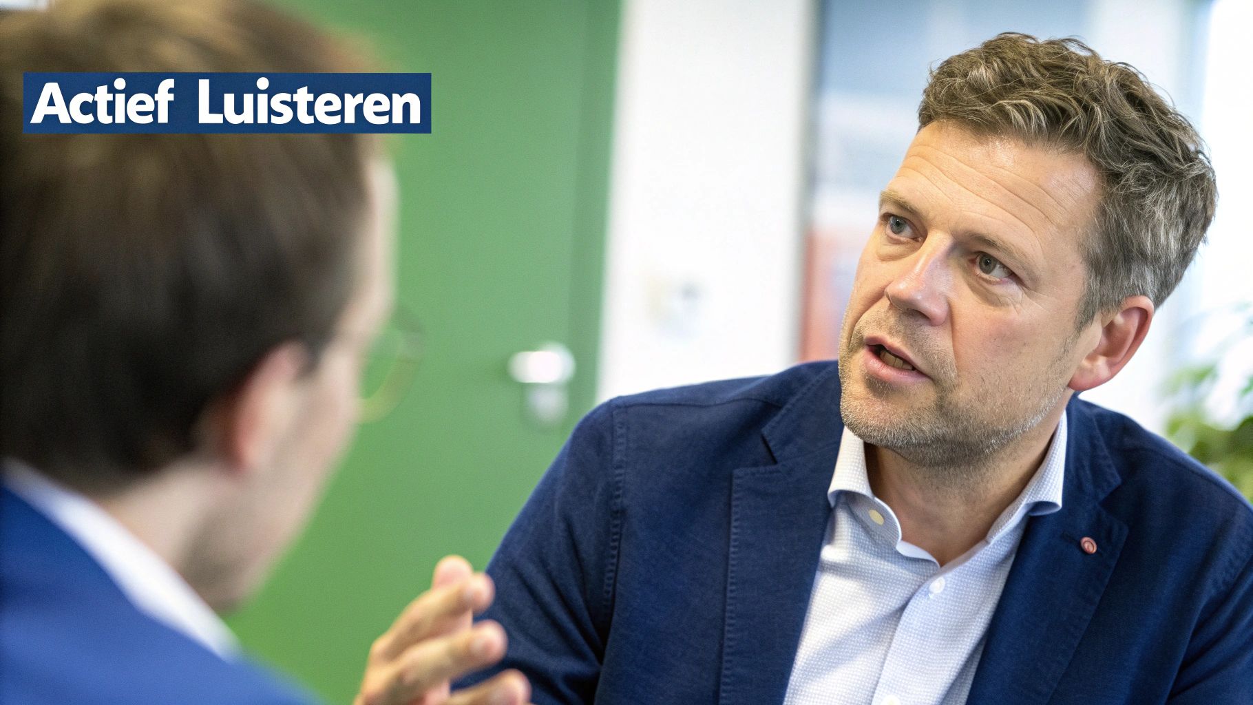 Manager coacht een medewerker aan een bureau