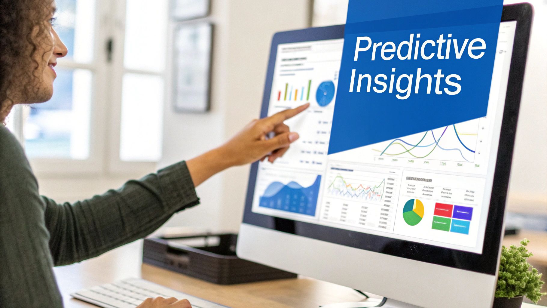 A woman points at a computer screen displaying various data analytics charts and 'Predictive Insights'.