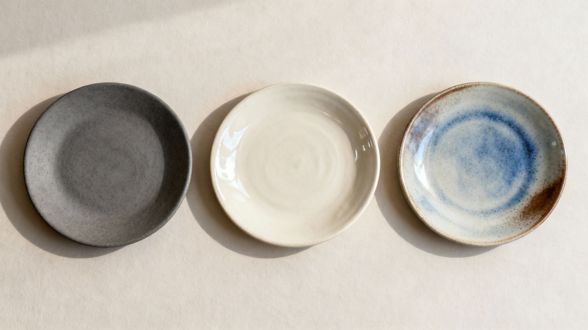 A collection of stoneware plates with different finishes