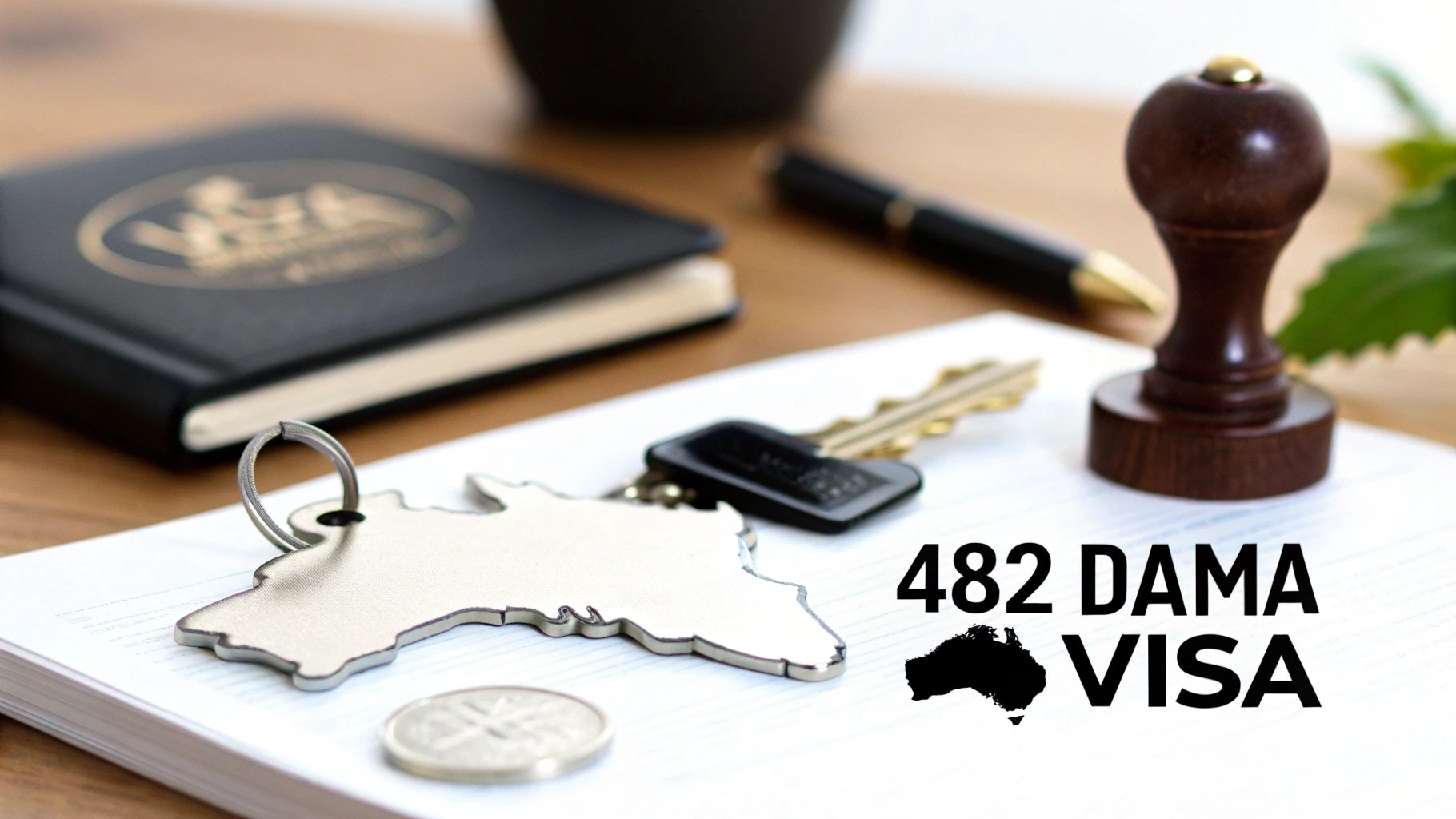 A desk with a notebook, pen, Australia map keychain, and '482 DAMA VISA' text.